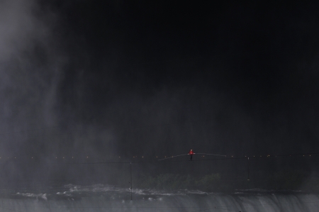 NIAGARA FALLS -JUNE 15: Nik Wallanda just after he started his walk from the USA side while crossing the Niagara Falls on a tightrope on June 15 2012 in Niagara Falls, Canada.のeditorial素材