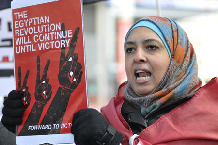 TORONTO - JANUARY 21: An Egyptian woman participating in a rally at Yonge and Dundas square during...