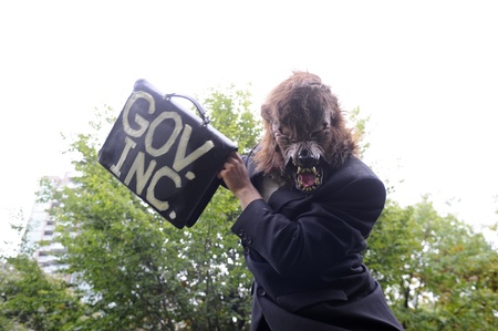 TORONTO - OCTOBER 15: A protestor masked as a wolf makes mockery of the \\\"government money\\\" during the Occupy Toronto Movement on October 15, 2011 in Toronto, Canada.のeditorial素材