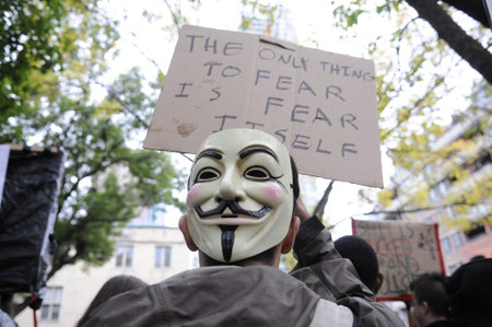 TORONTO - OCTOBER 15: A protestor listening to the speakers during the Occupy Toronto Movement on...