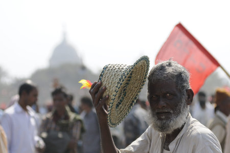 KOLKATA- FEBRUARY 13: A vendor selling hats looks at the camera during a political rally in Kolkata,...