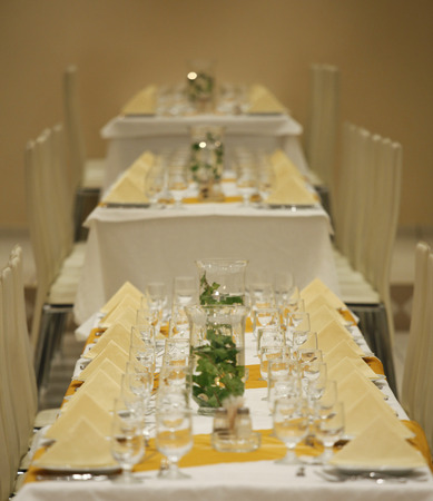 decorated tables with served plates and wine glassesの写真素材
