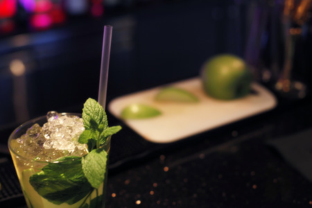 mojito and cut lime in the backgroundの写真素材