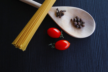 spaghetti, spices and cherry tomatoes shot from topの写真素材