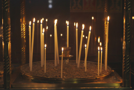 Large group of burning candles in churchの写真素材