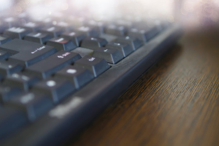 Black computer Keyboard on wooden deskの写真素材