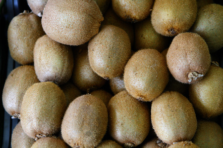 Bunch of fresh kiwis in a grocery shopの写真素材