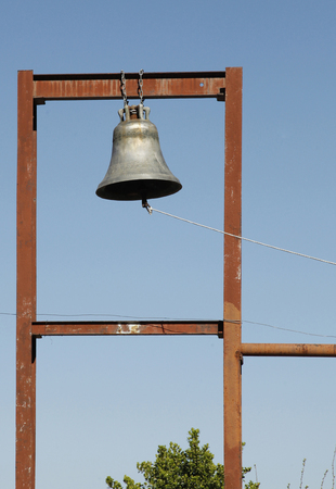 Old church bell hanged with iron chainの写真素材