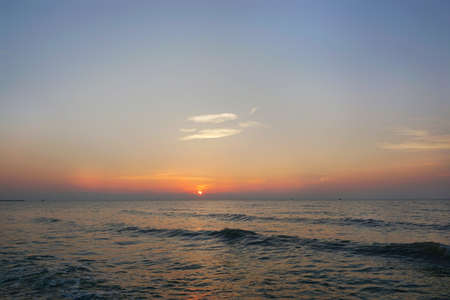 Morning on sea, Beautiful nature blue sky with clouds. Colorful sky as a background. Soft wave of the sea on the sandy beach at  Cha-am beach, Thailand. Space for text in template. Empty.の写真素材