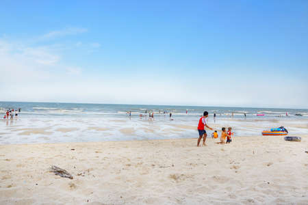 PRACHUAP KHIRI KHAN, THAILAND - APRIL 20, 2018 : People playing the sea at cha am beach. Many tourists visit here. View for seascape. Space for text in template.のeditorial素材