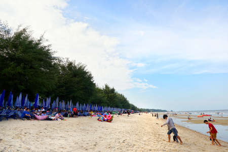 PRACHUAP KHIRI KHAN, THAILAND - APRIL 20, 2018 : People playing the sea at cha am beach. View for seascape. Space for text in template.のeditorial素材