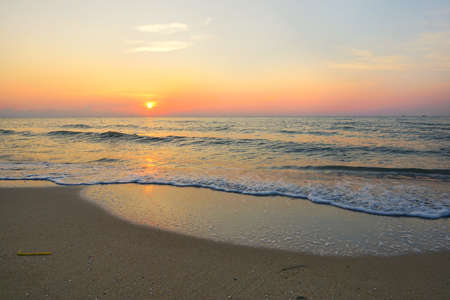 Morning on sea, Beautiful nature blue sky with clouds. Colorful sky as a background. Soft wave of the sea on the sandy beach at  Cha-am beach, Thailand. Space for text in template. Empty.の写真素材