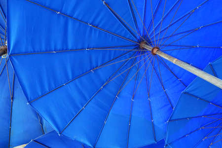 Looking up at a blue parasol, big umbrellas at the Cha am beach, Thailandの写真素材
