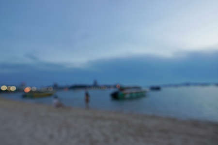 Blurred view of people having sunset beach in summer vacation as twilight times at Pattaya beach in Thailand. tourists take a photo with sea. View for seascape. Summer holiday and vacation concept for tourismの写真素材