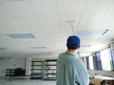 Close up of man at work painting a roof of new office, Copy spaceの写真素材