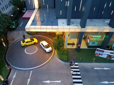 BANGKOK, THAILAND - MAY 04, 2018 : Top view of temporary parking in front of Ibis Siam Hotel and people walking across the crosswalk in the evening, Space for text in template, Many tourists come hereのeditorial素材