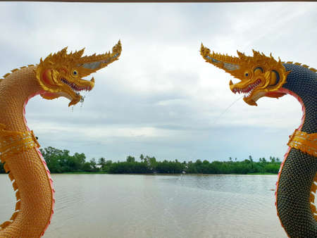 Serpent sculpture with Bang Pakong River on the blue sky background in the temple at Thailand, King...