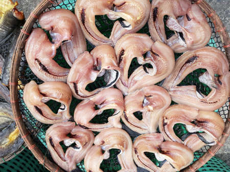 Top view of  salted dried on wooden basket in the market for sale at Thailand (Trichogaster pectoralis, Osphronemidae, Snake-skined gourami)の写真素材