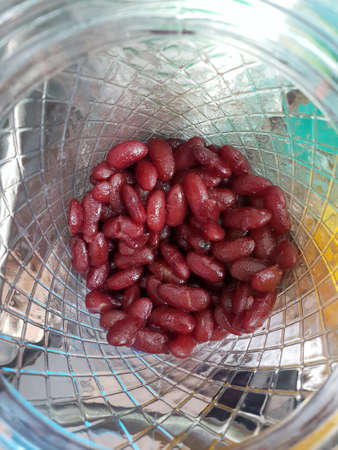 Top view of cooked red kidney beans in glass bowl for making Thai desserts, Vertical
