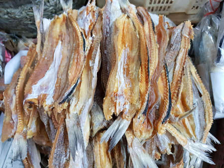 Top view of dried salted fish for cooking, for sale in the fish market, as a background (Striped...