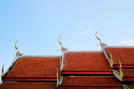 Roof of Thai temple  on blue sky and cloud as a background, Religion concept