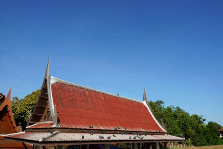 Roof of Thai temple on blue sky and cloud as a background, Religion conceptの写真素材