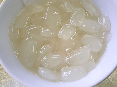 Top view of sugar palm fruit on white bowl, for making desserts, captured ready to eatの写真素材