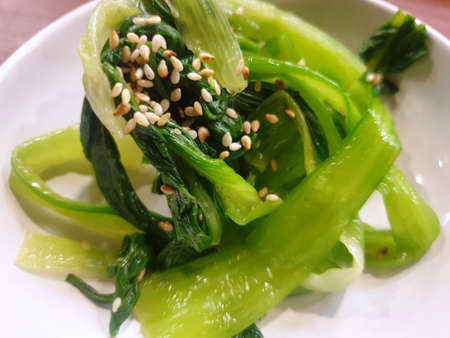 Soft Focus of blanched spinach and cooked with sesame oil, minced garlic, soy sauce and sprinkled with sesame seeds as a background, Piramnamul is Korea traditional, Selective focusの写真素材