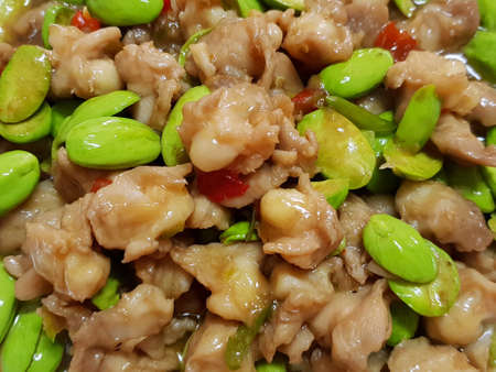 Thai food style, Selective focus of spicy fried chicken tendon with stink bean as a background, Sataw is Thai traditional (Parkia speciosa), Soft focusの写真素材