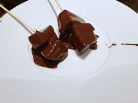 Top view of hot chocolate stick on white plate in in cafÃ©, Ready to eat or serve, Selective...