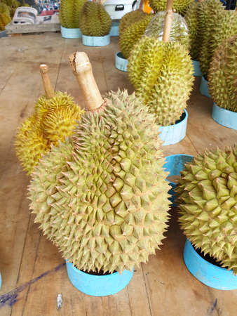 Top view of durian fruit on wooden table for sale in the market, Tropical fruit, copy space...