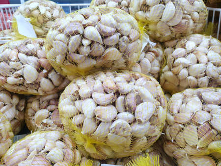 Fresh garlics in package for sale on the market at Thailand, Top view (Allium sativum)