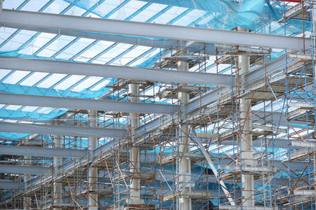 The structure of building as a background, Steel construction in large construction site, Space for...