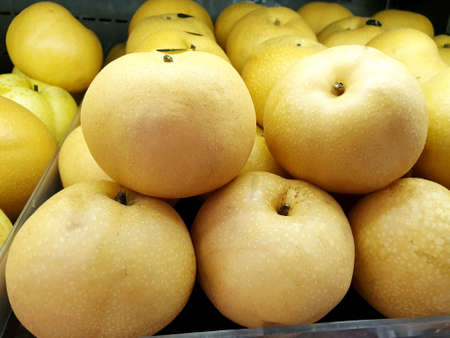 Pile of Chinese pear for sale on market stand in supermarket, Ready to eat, space for your text