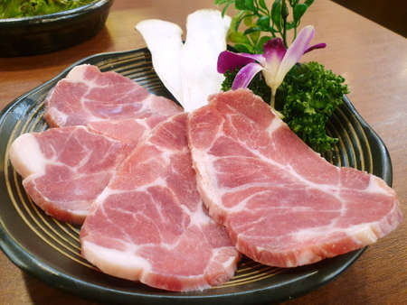 Top view of pork sliced on plate in the restaurant, fresh meat for grill or cookingの写真素材