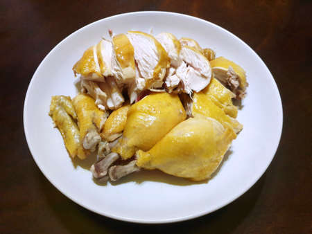 Chinese food style, Top view of boiled chicken meat in white plate on wooden table, Chinese new year food, Read to eat or serveの写真素材
