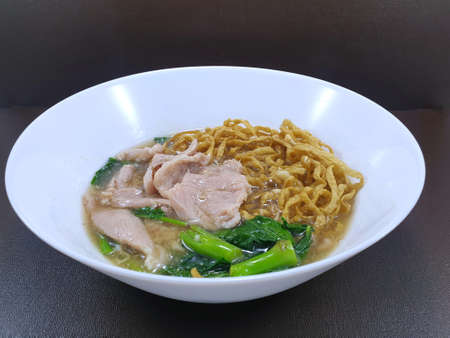 Top view of fried noodle with pork and chinese kale on wooden table as a background, This food is most popular and simple food (Rad Na), Ready to eatの写真素材