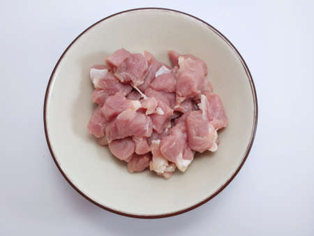 Top view of pork sliced in white bowl isolated on whiteの写真素材
