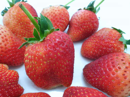Heap of fresh strawberries isolated on white background, Strawberry as a background ,Selective focus, Fresh fruit ready to eat or making drinks and salads, Healthy conceptの写真素材