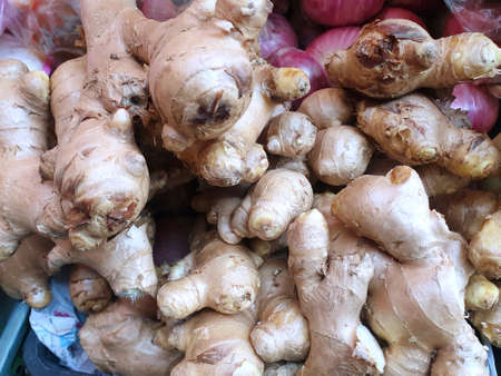 Top view of fresh ginger for sale as a background on the market, for cookingの写真素材
