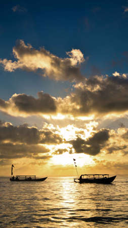 silhouette of boats on the seaの写真素材