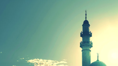 A mosque silhouetted against the rising sun.の素材