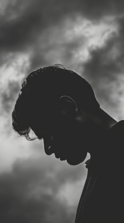 A man standing against a backdrop of cloudy sky.の素材