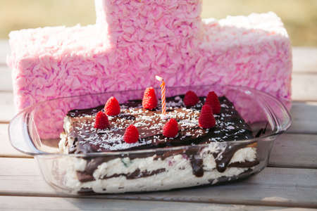 homemade chocolate birthday cake with fresh berries and one candle
