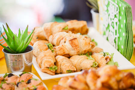 buffet for celebration birthday food on plates, home made sandwiches and decorationsの写真素材