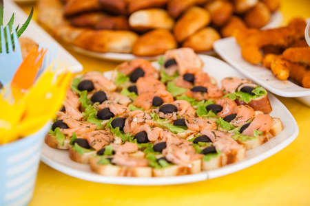 buffet for celebration birthday food on plates, home made sandwiches and decorations