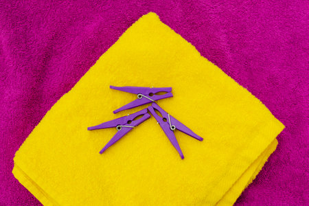 Bath towels in bright colors and clothespins, flat lay. Horizontal photo with copy spaceの写真素材