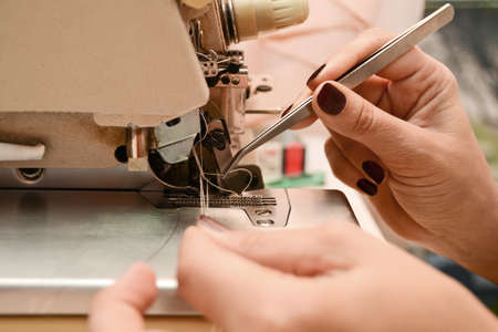 The seamstress works at the sewing machine. Fulfillment of the order by an individual entrepreneur. small business conceptの写真素材