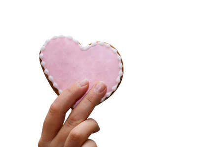 Glazed heart-shaped cookies in women's hand. Valentine's day is a delicious home-made natural...