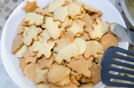 Ready-made shortbread cookies on white plate close-up. Homemade and handmade food conceptの写真素材